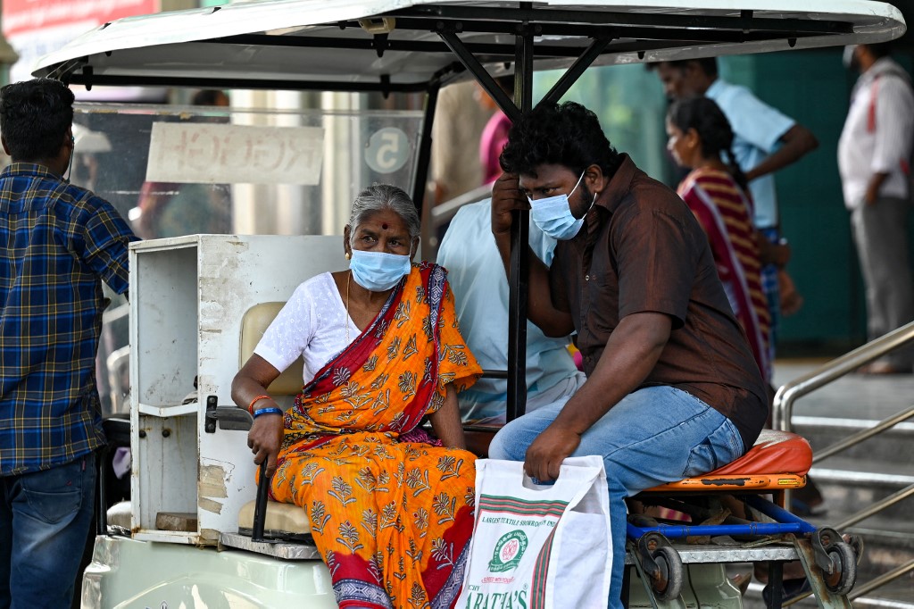 People wear face masks as they arrive at a government hospital, since a rise in Covid-19 coronavirus cases, in Chennai on April 1, 2023. (AFP)