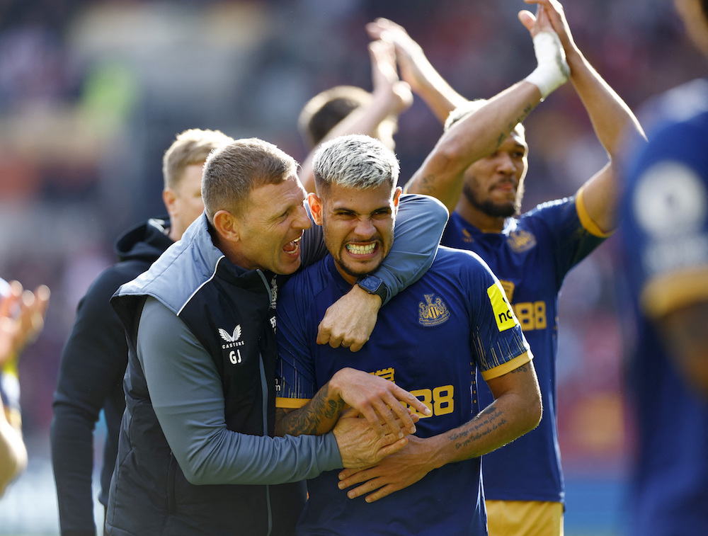 Newcastle United’s Bruno Guimaraes celebrates with head coach Graeme Jones after the match. (Action Images via Reuters)