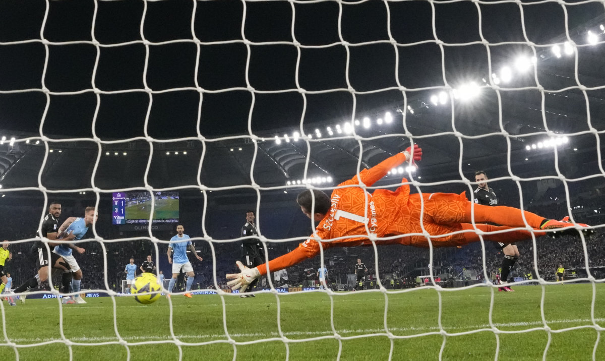 Juventus' goalkeeper Wojciech Szczesny fails to save shot by Lazio's Mattia Zaccagni, second left, who scored his side's second goal during their Italian Serie A soccer match at the Stadio Olimpico stadium in Rome Saturday. (AP)