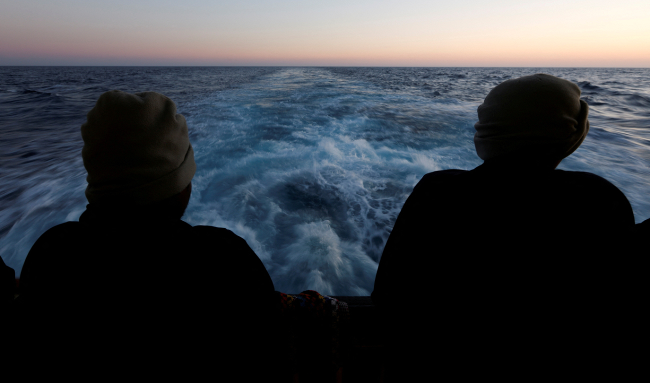 Rescued migrants look out to sea on the Geo Barents rescue ship, operated by Medecins Sans Frontieres (Doctors Without Borders), as the ship makes its way to the Italian port of Bari, in the central Mediterranean Sea March 25, 2023. (Reuters/File)