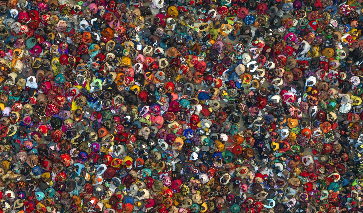 Hindu devotees listen to a religious leader at the Sangam, the confluence of the Ganges, Yamuna and mythical Saraswati rivers, during the annual traditional fair of Magh Mela festival, in Prayagraj, in the northern Indian state of Uttar Pradesh, Jan. 31, 2023. (AP)