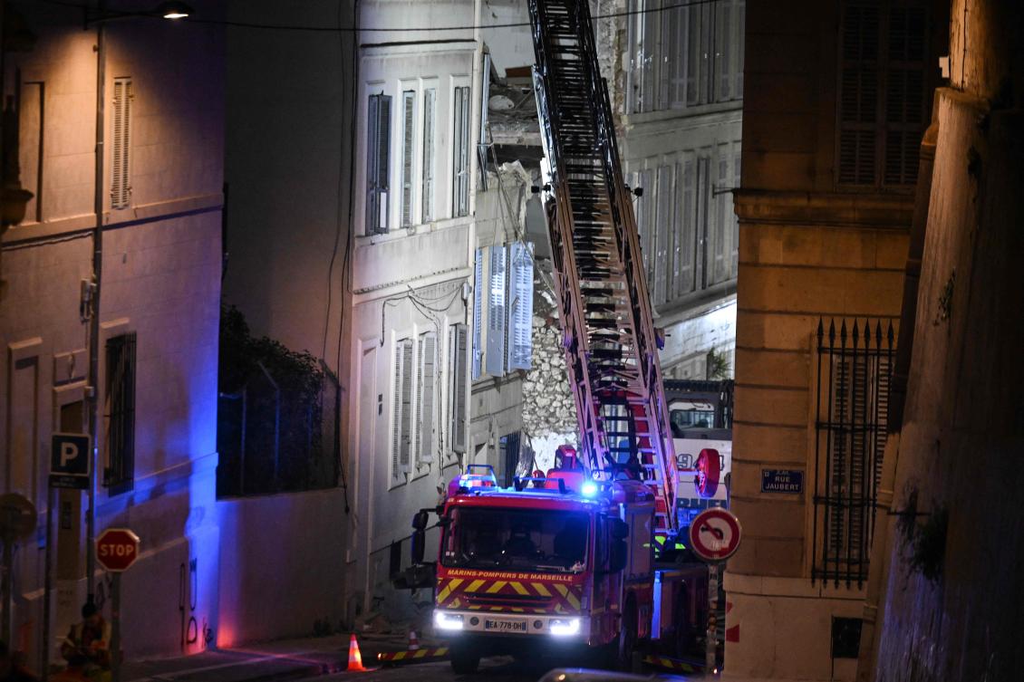 A firetruck extends a ladder at the scene of a collapsed building on 'rue Tivoli', in Marseille, southern France, on April 10, 2023. (AFP)