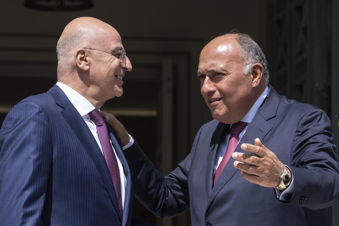 Greek Foreign Minister, Nikos Dendias welcomes his Egyptian counterpart Sameh Shoukry, as they meet in Athens on Apr. 11, 2023. (AP)
