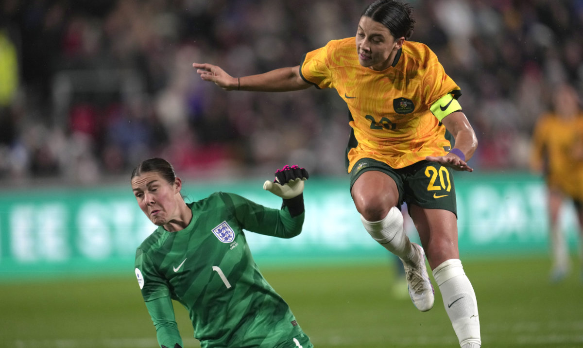 Australia's Sam Kerr, right, scores against England during the women's international friendly soccer match between England and Australia at the Gtech Community Stadium in London Tuesday. (AP)