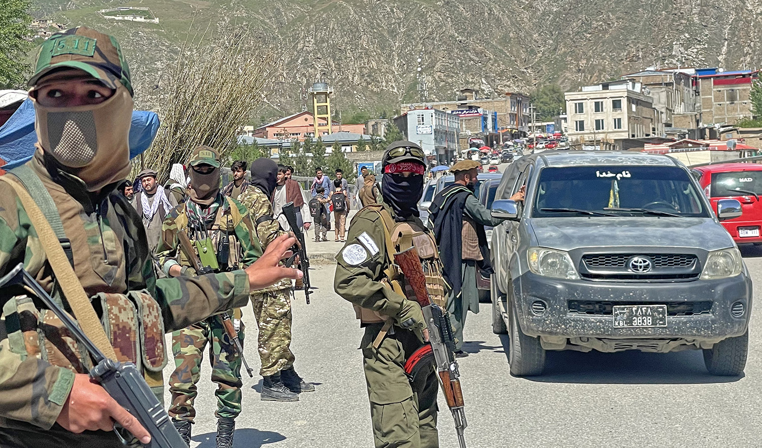 Taliban security personnel stand guard along a street to remove the window tint films from the cars of the commuters at a checkpoint in Fayzabad district of Badakhshan province on April 4, 2023. (AFP)