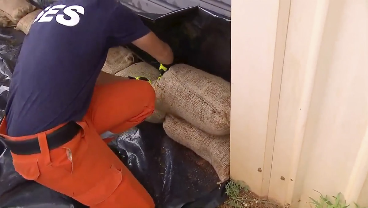 This image made from a video shows State Emergency Services (SES) workers sandbagging in Port Hedland, Australia on April 12, 2023 as an intensifying Tropical Cyclone Ilsa approached. (Australian Broadcasting Corporation via AP)