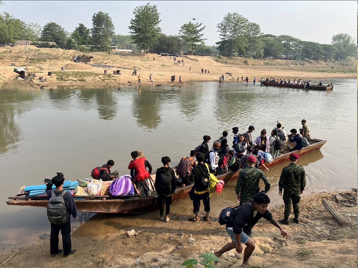 This handout photo taken and released on April 11, 2023 by the Royal Thai Army shows people from Myanmar crossing the Moei river on the Thai-Myanmar border. Thousands of people who had fled into Thailand following fighting between Myanmar rebels and the military. (AFP)