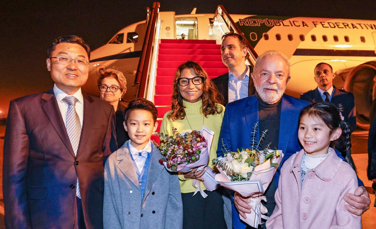 Brazilian president Luiz Inacio Lula da Silva, right, and his wife Rosangela are welcomed upon their arrival in Shanghai, China for an official visit to the country on April 12, 2023. (Brazilian Presidency via AFP)