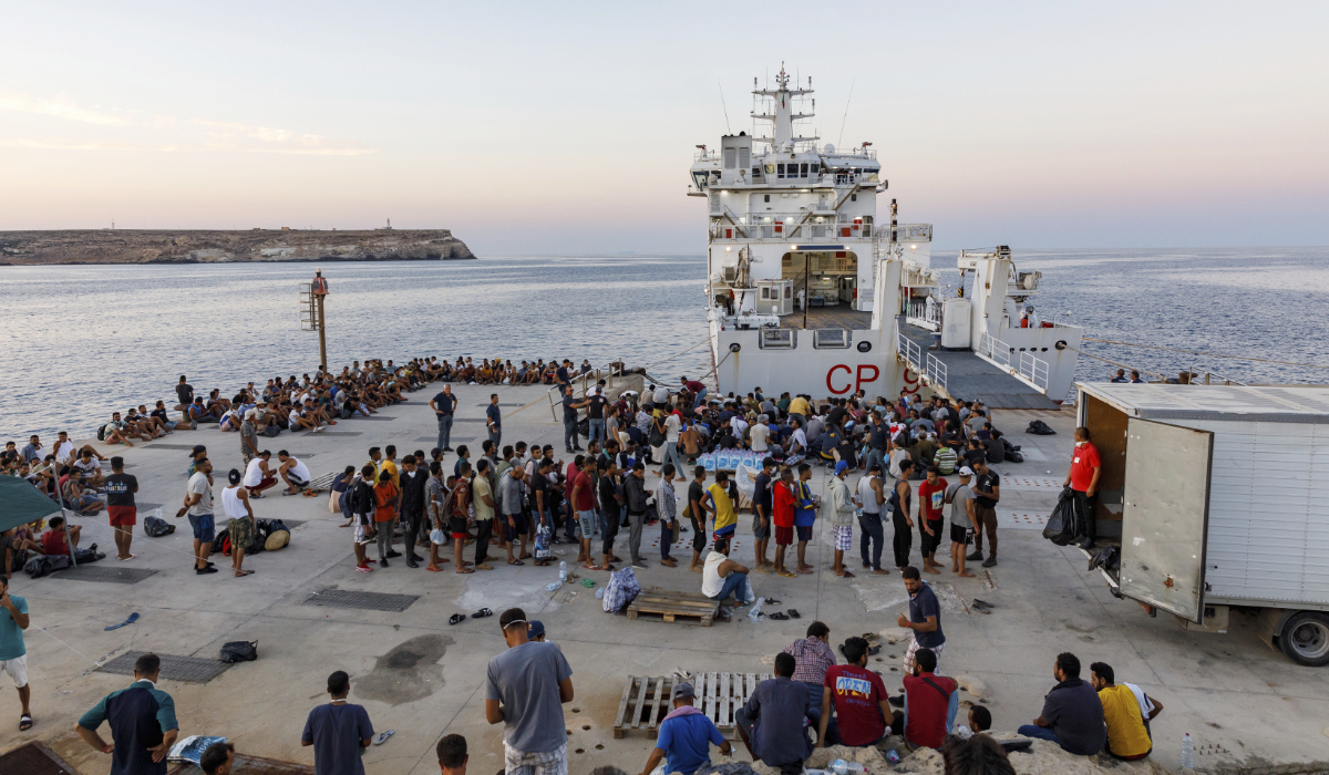Migrants wait to board an Italian Coast Guard ship in the Sicilian Island of Lampedusa, Italy, Wednesday, Aug. 3, 2022. (AP)