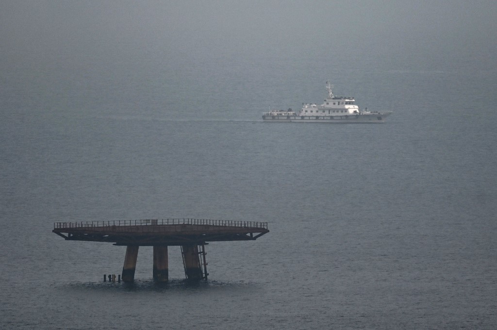 A lone ship (R) sits at the entrance to a bay where live fire exercises were being held on land on Pingtan island, the closest point in China to Taiwan, in southeast China’s Fujian province. (File/AFP)
