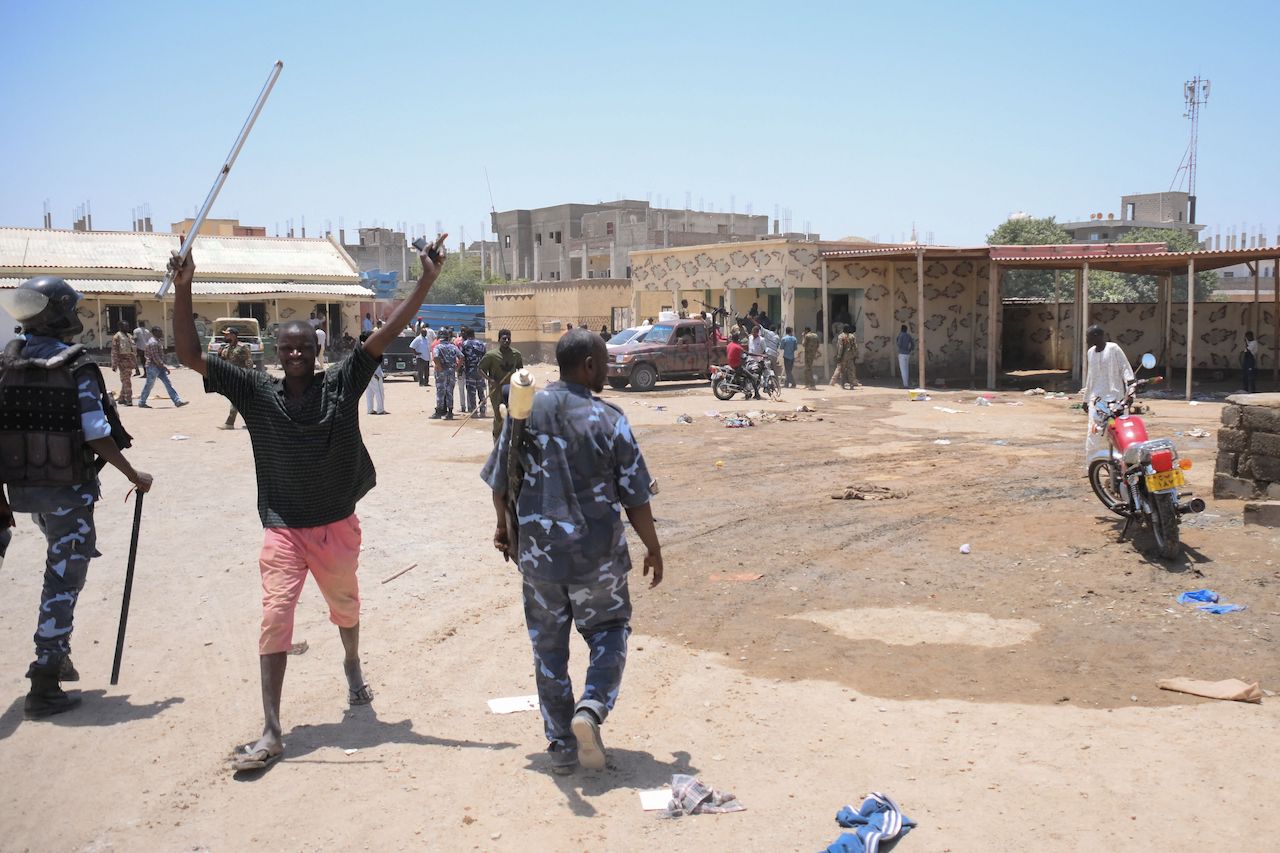 This picture taken on April 16, 2023, shows Sudanese army soldiers, loyal to army chief Abdel Fattah al-Burhan, inspecting the Rapid Support Forces (RSF) base in the Red Sea city of Port Sudan. (AFP)