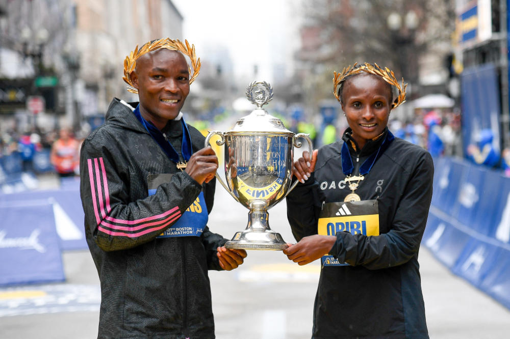 Evans Chebet of Kenya (left) and Hellen Obiri of Kenya (right) pose with the winner's trophy after winning their respective divisions in the 2023 Boston Marathon. Mandatory on Monday. (USA TODAY Sports)
