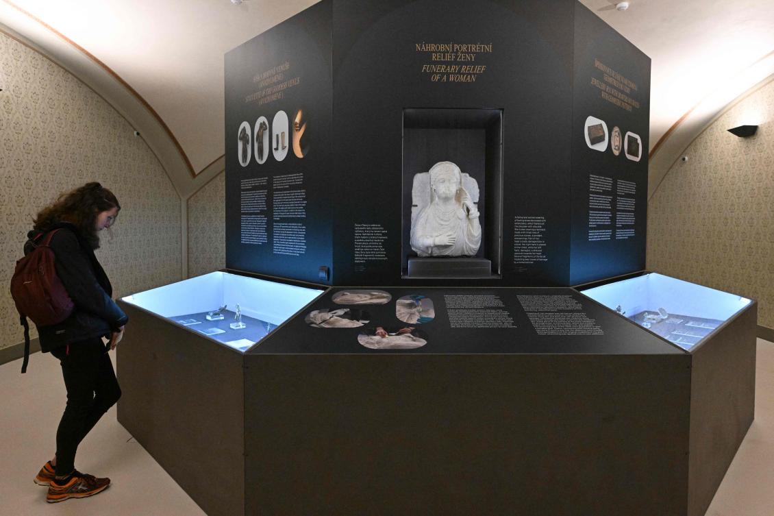 A woman looks at one of twenty artefacts repaired by Czech art restorers after being damaged during the civil war in Syria in the exhibition at Prague’s National Museum, Apr. 18, 2023. (AFP)