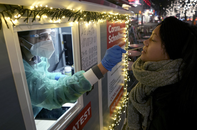 A health worker performs a coronavirus test at a shopping road in Berlin, Germany, on Dec. 21, 2021.(AP/File)