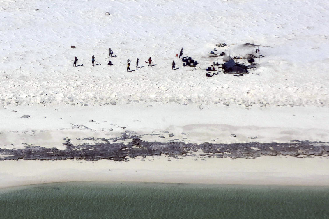 Fishermen from Indonesia stand on a beach on Bedwell Island, 313km west of Broome, Australia, on Monday, April 17, 2023. (Australian Maritime Safety Authority via AP)