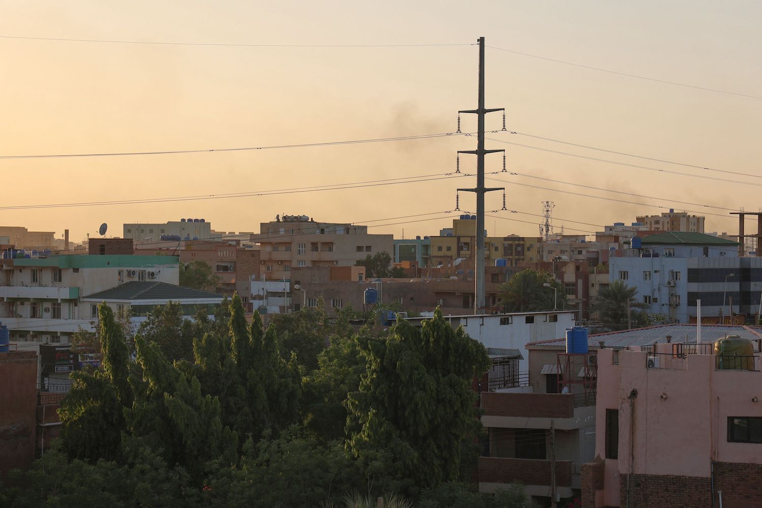 Smoke rises behind buildings in Khartoum on April 19, 2023, amid fighting between the army and paramilitaries following the collapse of a truce. (AFP)