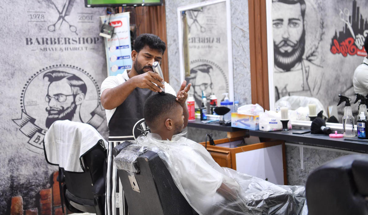 Barbershops at this time of the year employ additional workers to accommodate the demand and are open for long hours. (SPA)