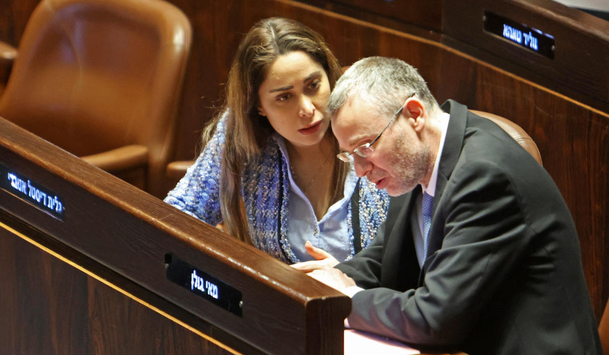 Israeli Justice Minister Yariv Levin (R) listens to MP May Golan during a session at the parliament, Knesset, in Jerusalem on March 20, 2023. (AFP)