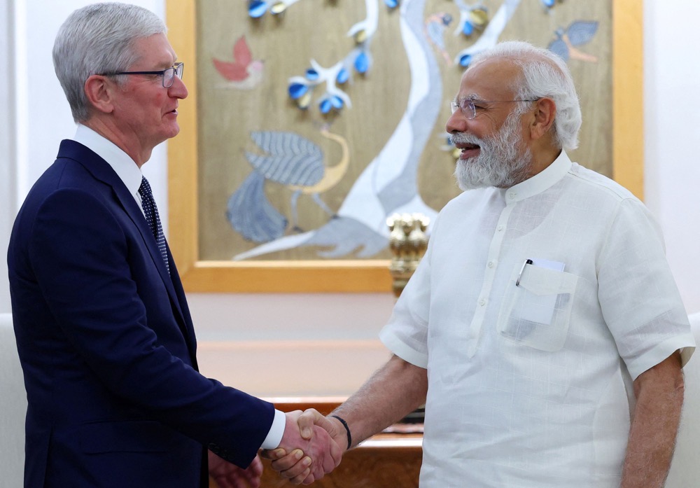 India's Prime Minister Narendra Modi shaking hands with Chief Executive Officer of Apple Tim Cook. (AFP/Indian Press Information Bureau)