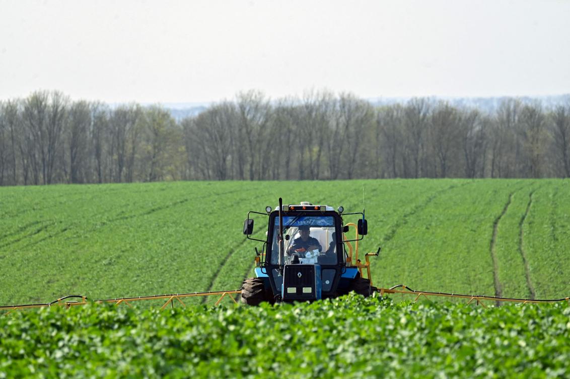 A farmer rides a floater truck spraying fertilizers on a farm in Kyiv region on April 19, 2023. (AFP)