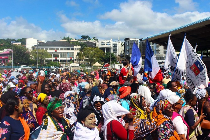 Protesters hold French and Mayotte flags as they gather on the Place de la Republique in Mamoutzou, on the French Indian Ocean island of Mayotte, in March 2018 during a demonstration against insecurity and immigration. (AFP/File)