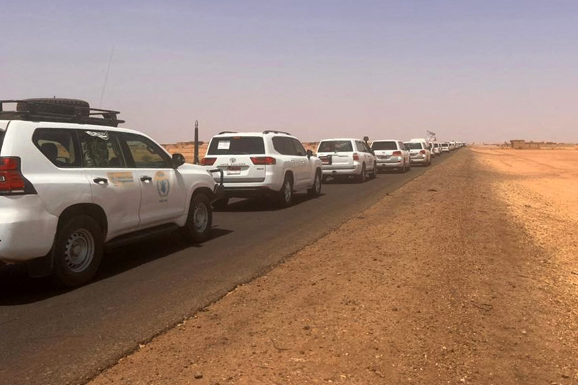 A convoy leaving Khartoum advances on a road towards Port Sudan, on April 23, 2023, as people flee the battle-torn Sudanese capital. (AFP)