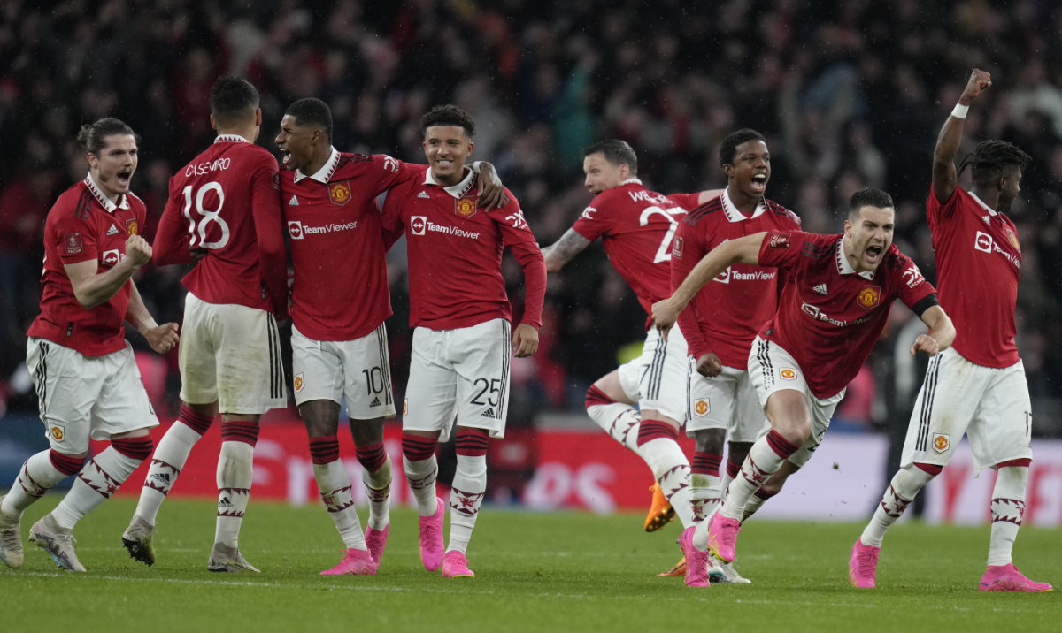 Manchester United players celebrate after winning the English FA Cup semifinal soccer match between Brighton and Hove Albion and Manchester United at Wembley Stadium in London, April 23, 2023. (AP)