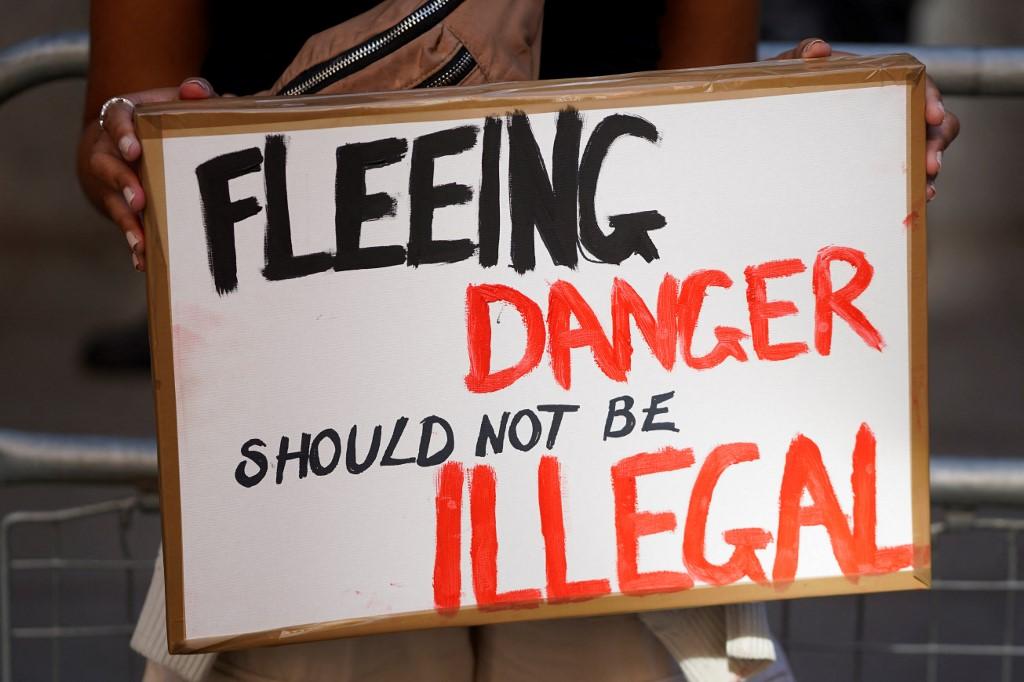 A protester stands outside the Home Office in central London to demonstrate against the UK government’s intention to deport asylum-seekers to Rwanda. (File/AFP)