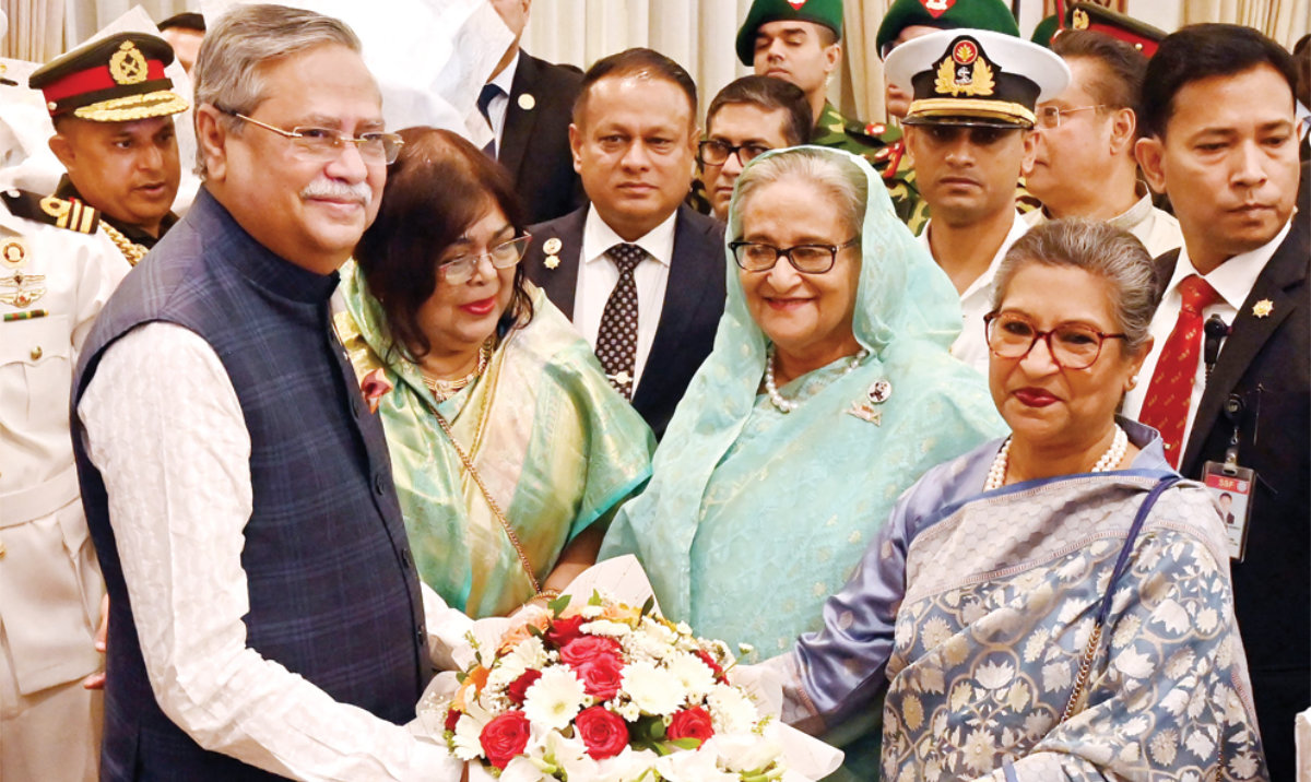 Bangladesh’s President Mohammed Shahabuddin receives floral wreath from Prime Minister Sheikh Hasina during an oath-taking ceremony in Dhaka. (AFP)