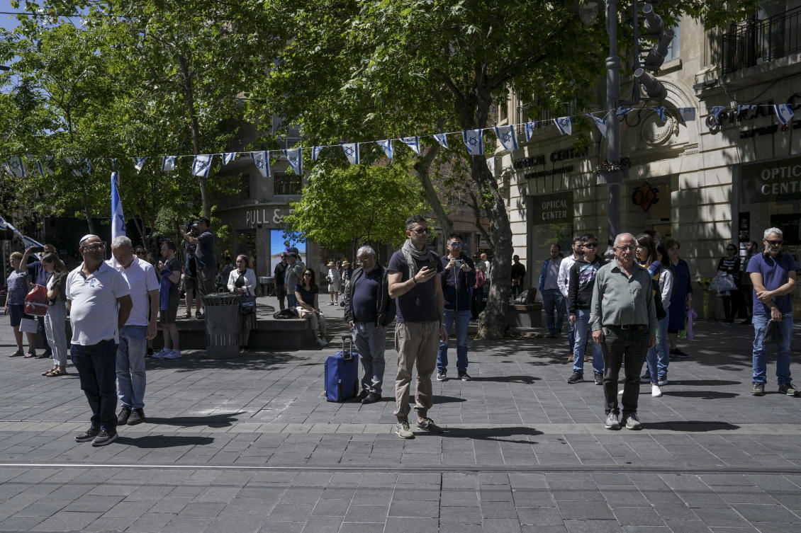 Residents stand still as air raid sirens sound to mark Israel’s annual Memorial Day for fallen soldiers in Jerusalem on April 25, 2023. (AP)