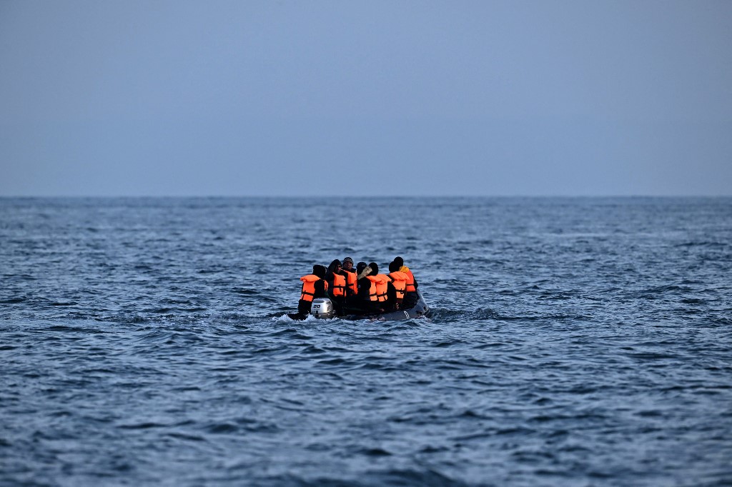 Migrants travel in an inflatable boat across the English Channel, bound for Dover on the south coast of England (AFP)