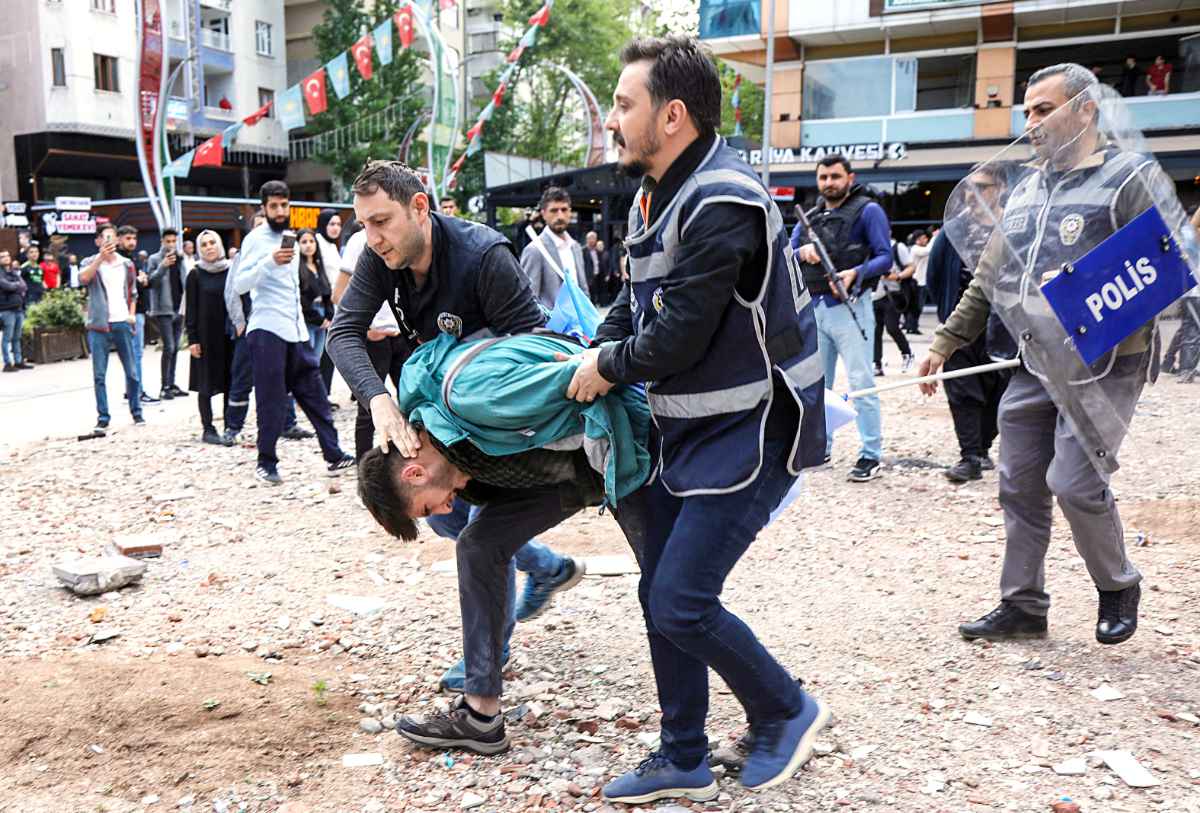 A man is detained by police officers after protesters chanted slogans against the detention of 110 people over alleged militant ties in Diyarbakir, Turkiye, on Tuesday. (Reuters)