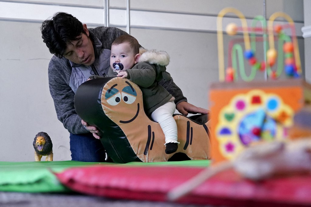 Afghan refugees play in a playroom of a hotel in Leeds, northern England on Nov. 30, 2021 which is being used to accommodate them. (AFP)