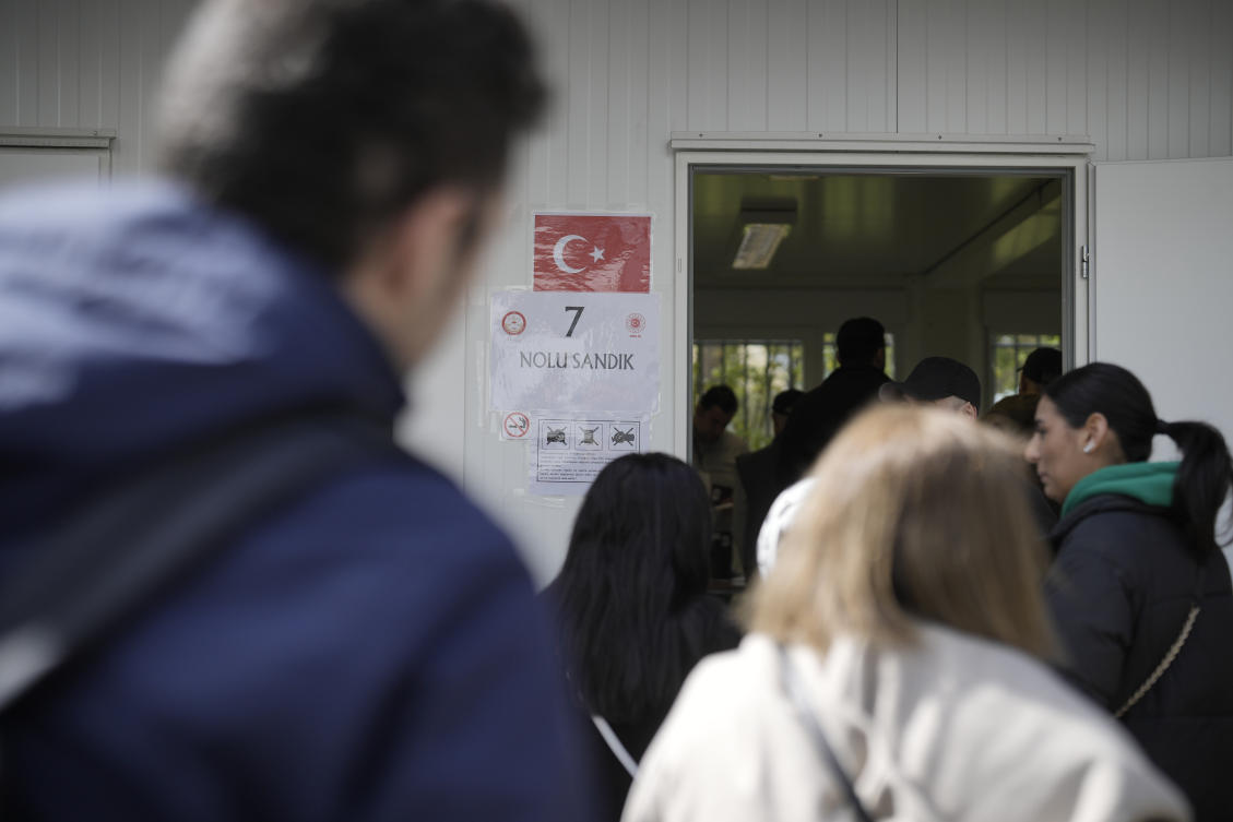 Turkish citizens living in Germany line up in front of a polling station at the Turkish consulate to cast their vote on April 27, 2023. (AP)