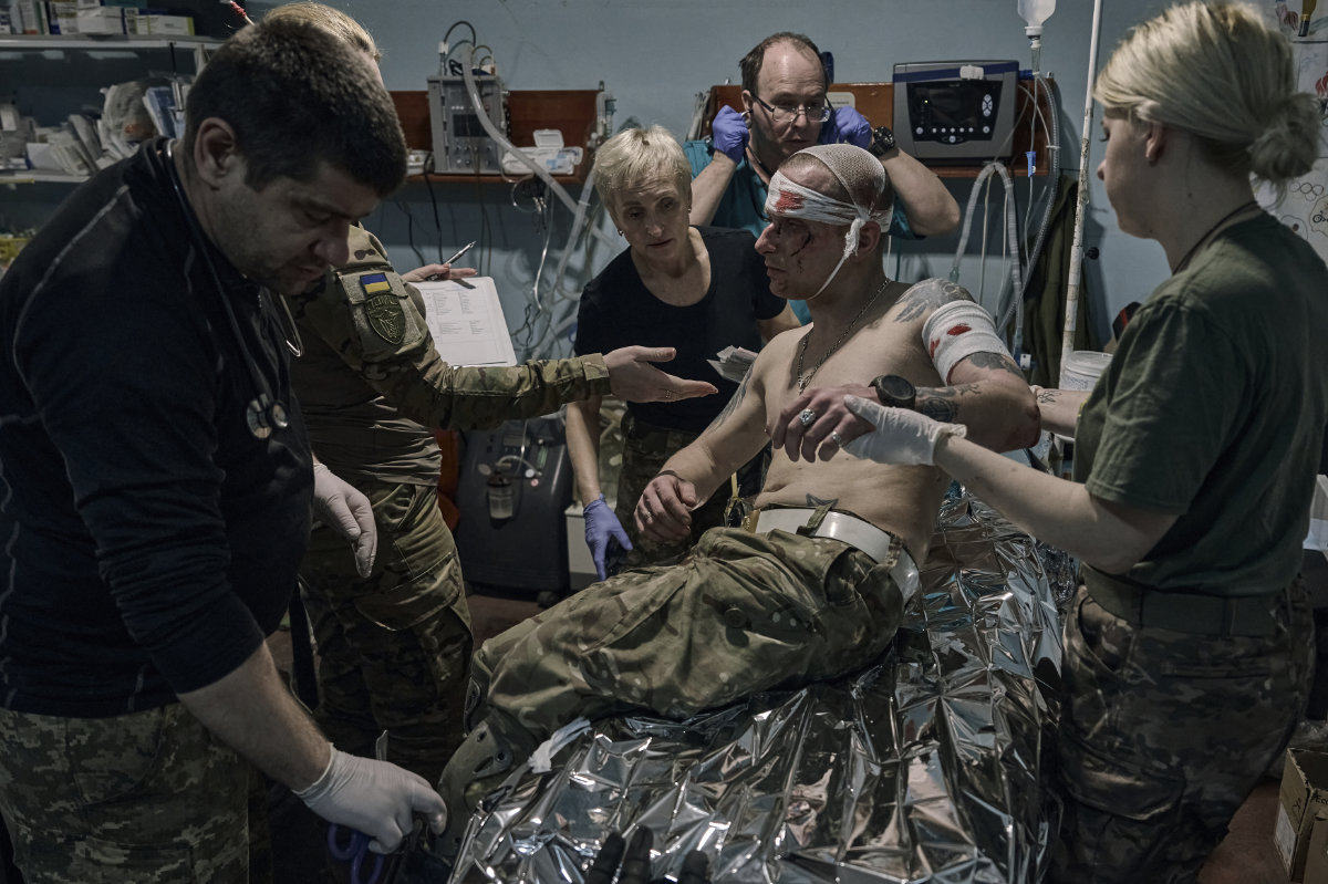 Medics give first aid to a wounded Ukrainian soldier at a medical stabilization point near Bakhmut, Donetsk region, on April 27, 2023. (AP Photo/Libkos)