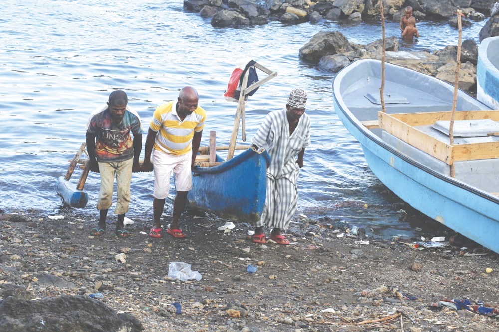 Fishermen carry a timber boat on the beach in Domoni, on the Anjouan island in the Comoros Archipelago. Almost half of Comoros’s 900,000 inhabitants live below the poverty line. (AFP)