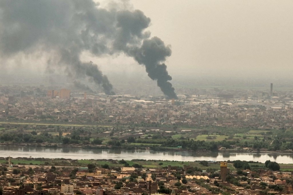 An aerial view of black smoke rising over Khartoum. Fighting raged in Sudan, despite rival forces agreeing to extend a truce aimed to stem nearly two weeks of warfare that has killed hundreds and caused widespread destruction. (AFP)