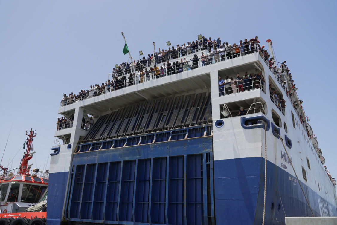 Civilians onboard a commercial ship are seen as it docks at Jeddah Sea Port, evacuated by Saudi Arabia from Sudan to escape the conflicts, Jeddah, Saudi Arabia, April 29, 2023. (Reuters)