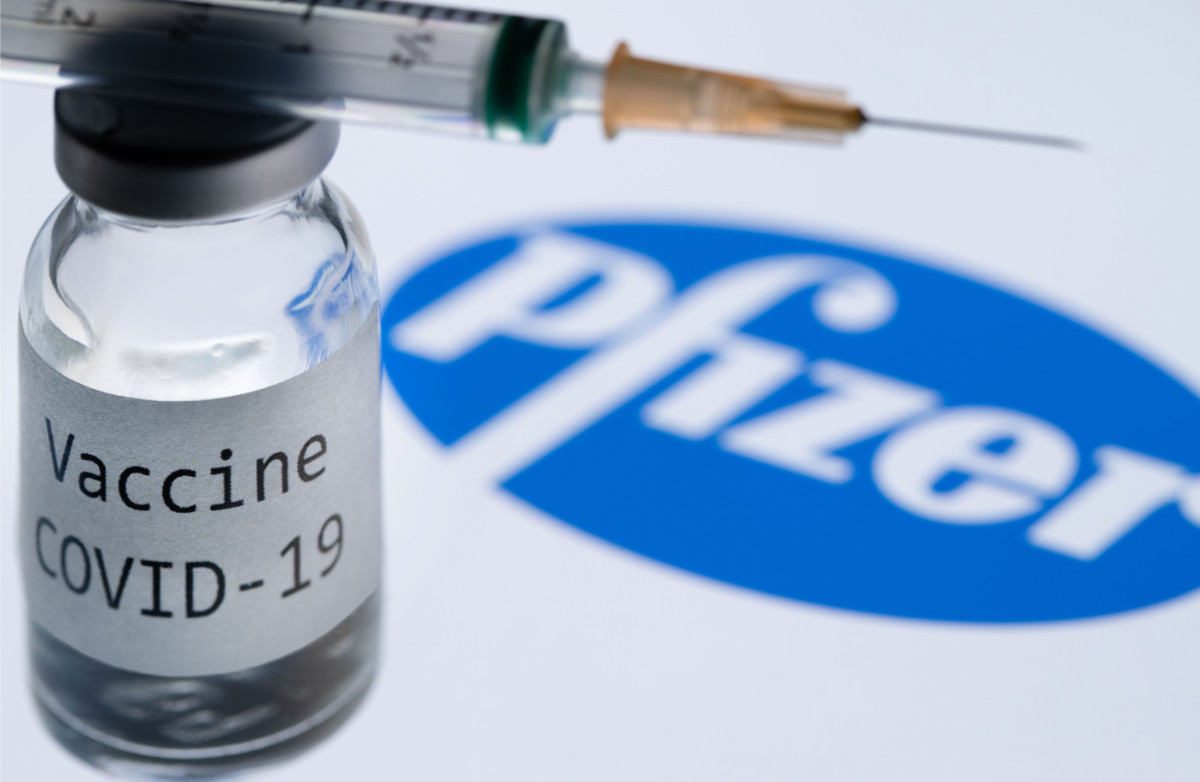 In this file photo taken on November 23, 2020, shows a syringe and a bottle reading 'Covid-19 Vaccine' next to the Pfizer company logo. (AFP)