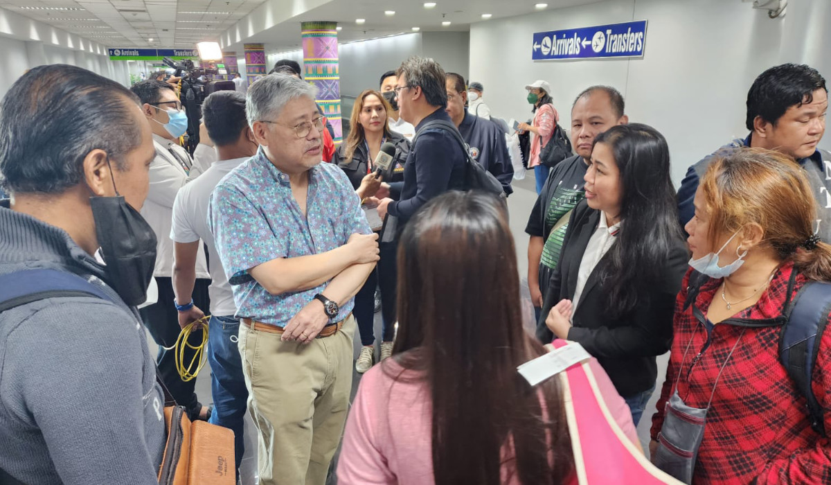 Foreign Affairs Secretary Enrique Manalo receives the first batch of Filipino evacuees from Sudan at Manila airport on Saturday. (Philippine Department of Foreign)