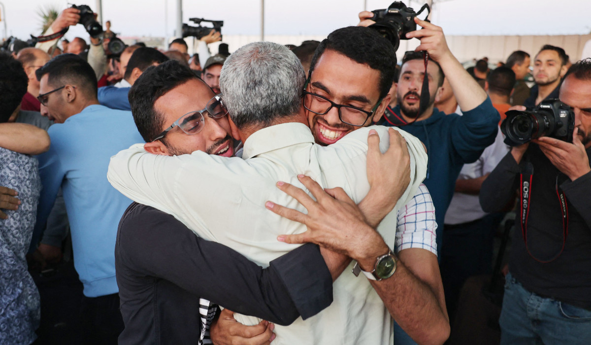 Relatives welcome Palestinian evacuees from war-torn Sudan upon arrival to the Gaza Strip through the Rafah border crossing with Egypt, on April 28, 2023. (AFP)