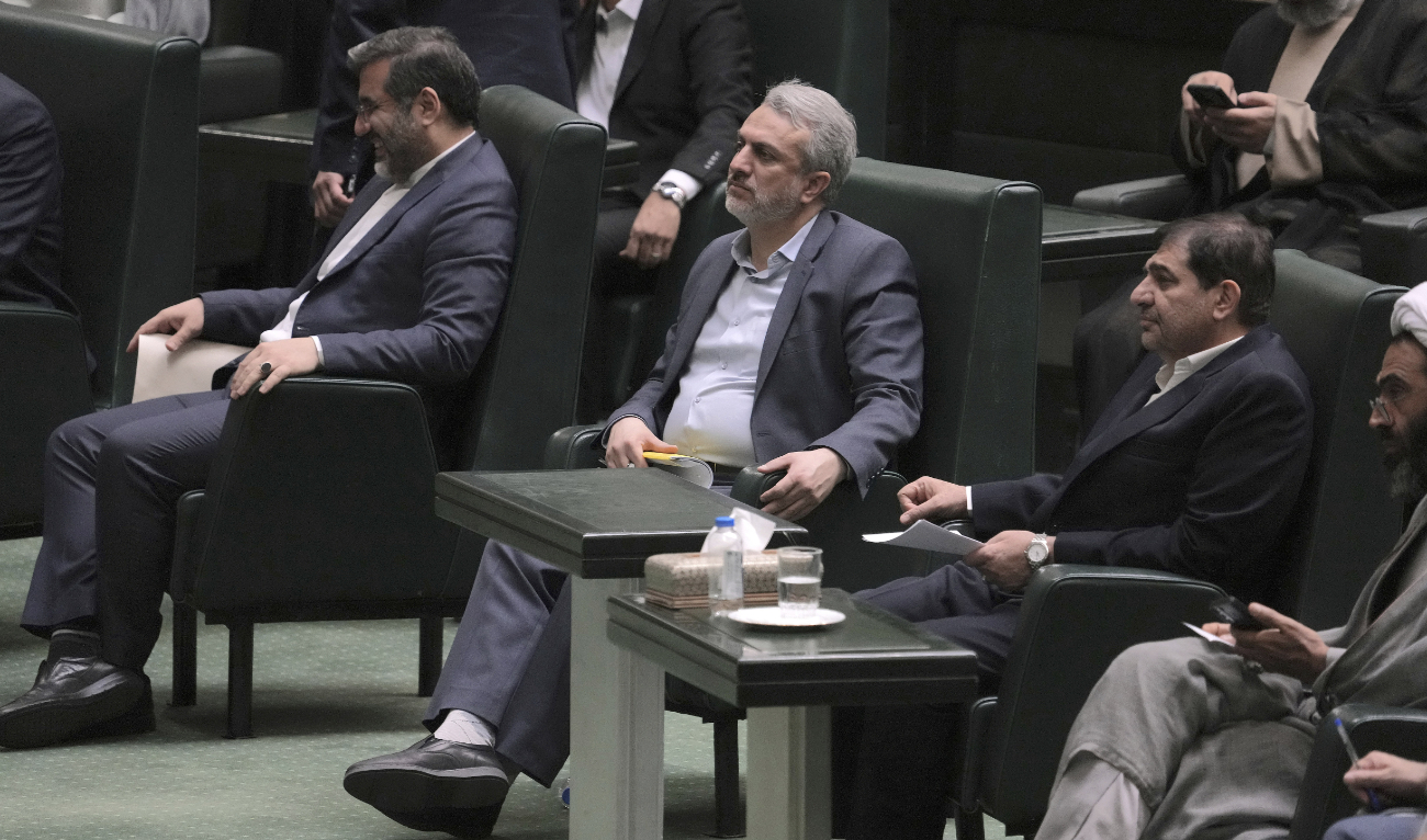 Iranian Industries Minister Reza Fatemi Amin, center, listens during an open session of parliament for his impeachment, in Tehran, Iran, Sunday, April 30, 2023. (AP)