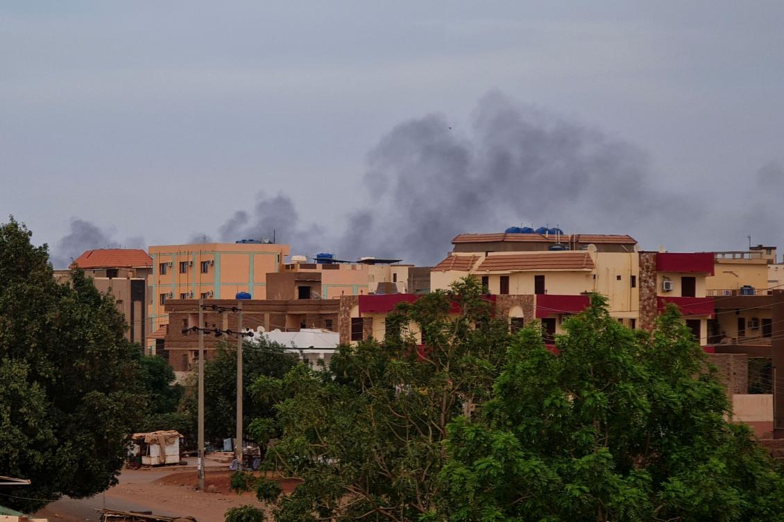 Smoke billows over residential buildings in Khartoum on April 30, 2023 as deadly clashes between rival generals’ forces entered their third week. (AFP)