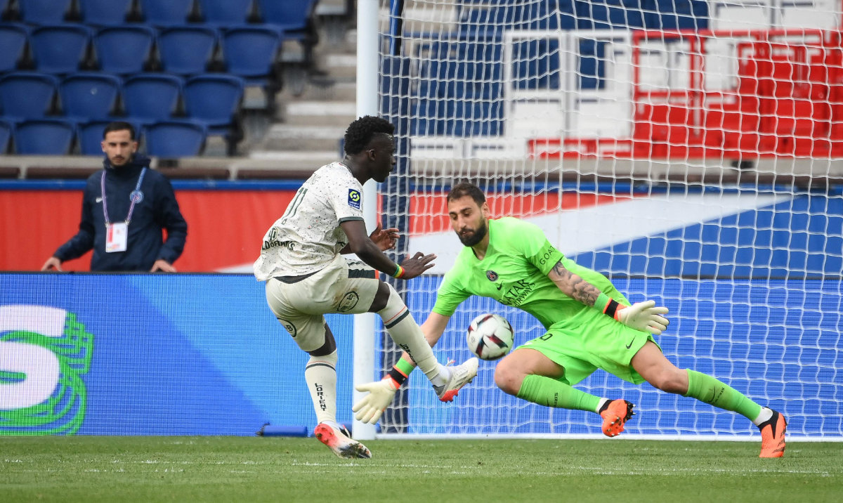 Lorient's Senegalese forward Bamba Dieng (C) kicks to score his team's third goal during the French L1 football match between Paris Saint-Germain and FC Lorient at The Parc des Princes Stadium in Paris on Sunday. (AFP)