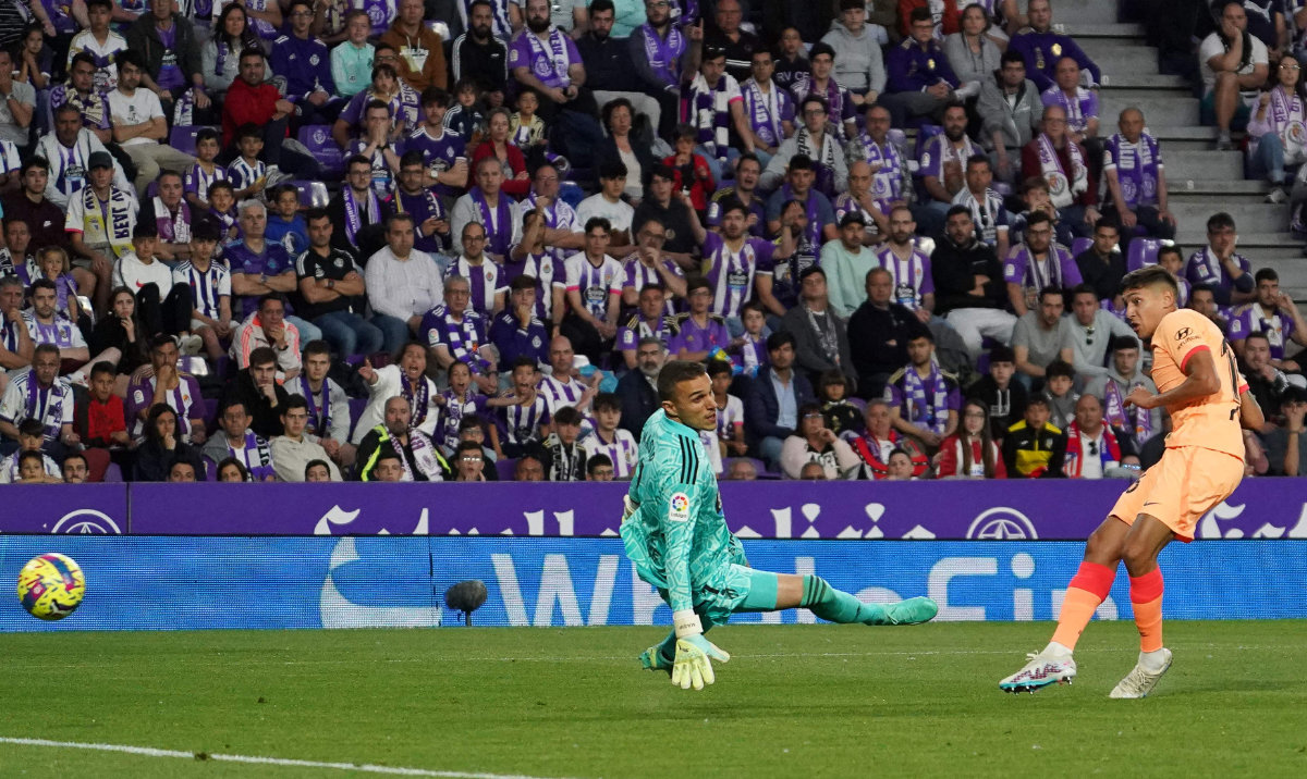 Atletico Madrid's Argentine defender Nahuel Molina (R) scores a goal past Real Valladolid's Spanish goalkeeper Jordi Masip during their Spanish league match at the Jose Zorilla stadium in Valladolid on Sunday. (AFP)