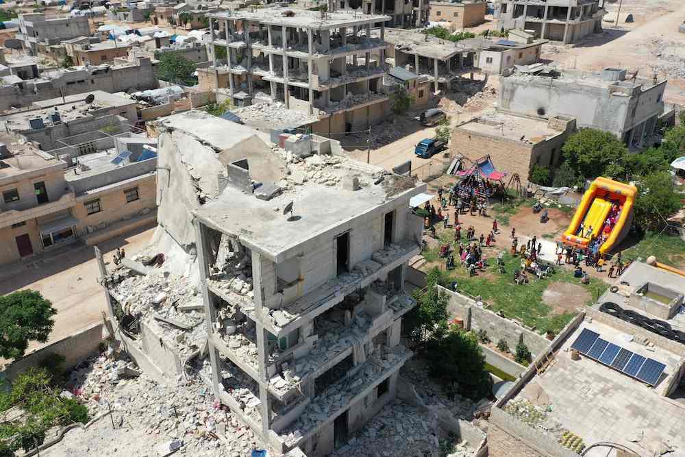 A makeshift amusement parkset up amidst buildings damaged in the earthquake that hit in February, in Jindayris in the Syrian province of Aleppo. (AFP)