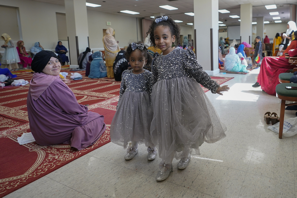 Sisters wearing matching dresses after prayers at the Muslim Community Center in Silver Spring, Maryland. (AP)