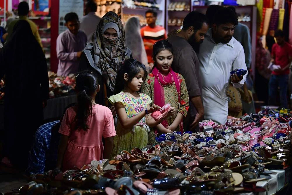 A girl looks at shoes during shopping on the eve of Eid Al-Fitr festival, which marks the end of the holy fasting month of Ramadan, in Karachi. (AFP)