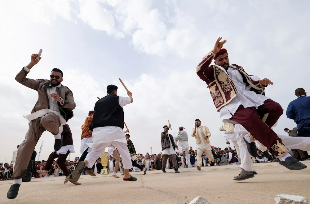 Libyans dressed in traditional costumes perform a folk dance during a carnival in a public square in Benghazi, Libya. (Reuters)