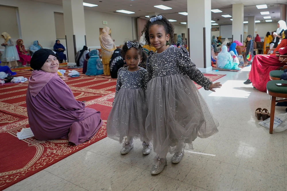 Sisters wearing matching dresses after prayers at the Muslim Community Center in Silver Spring, Maryland. (AP)